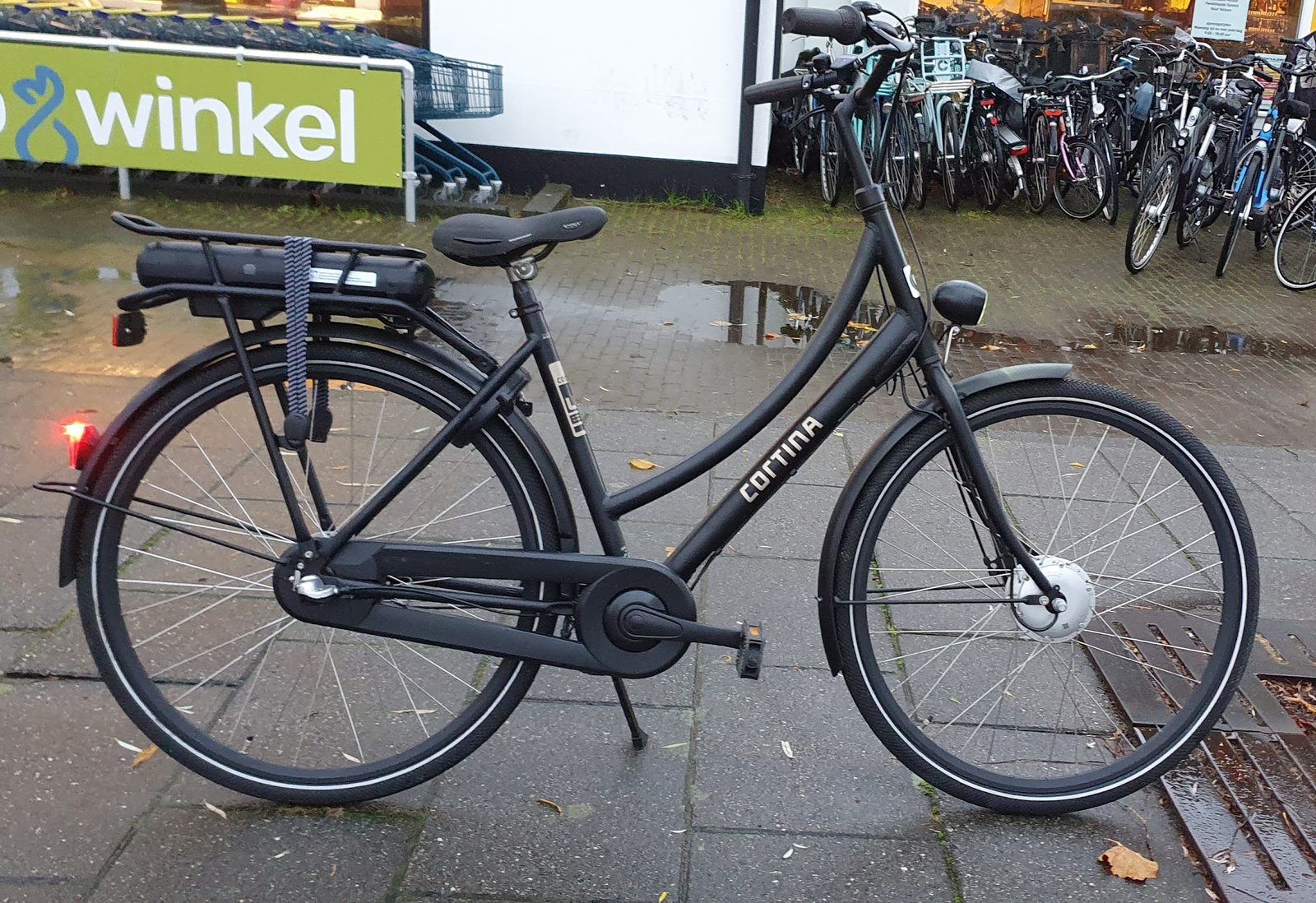 Zwarte Cortina e-bike met accu op de bagagedrager